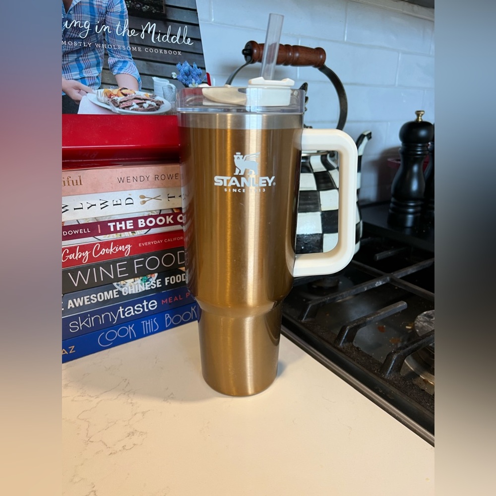 Gold Stanley 40oz travel quencher with cover and straw